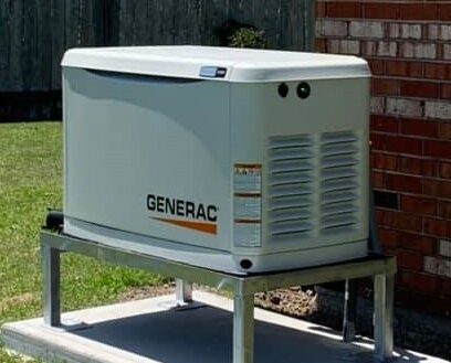 A stationary Generac home backup generator installed on a concrete pad outdoors.